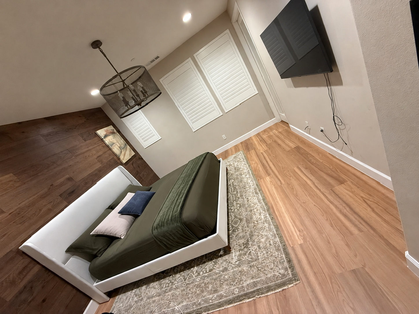 Furnished primary bedroom with luxury vinyl plank flooring